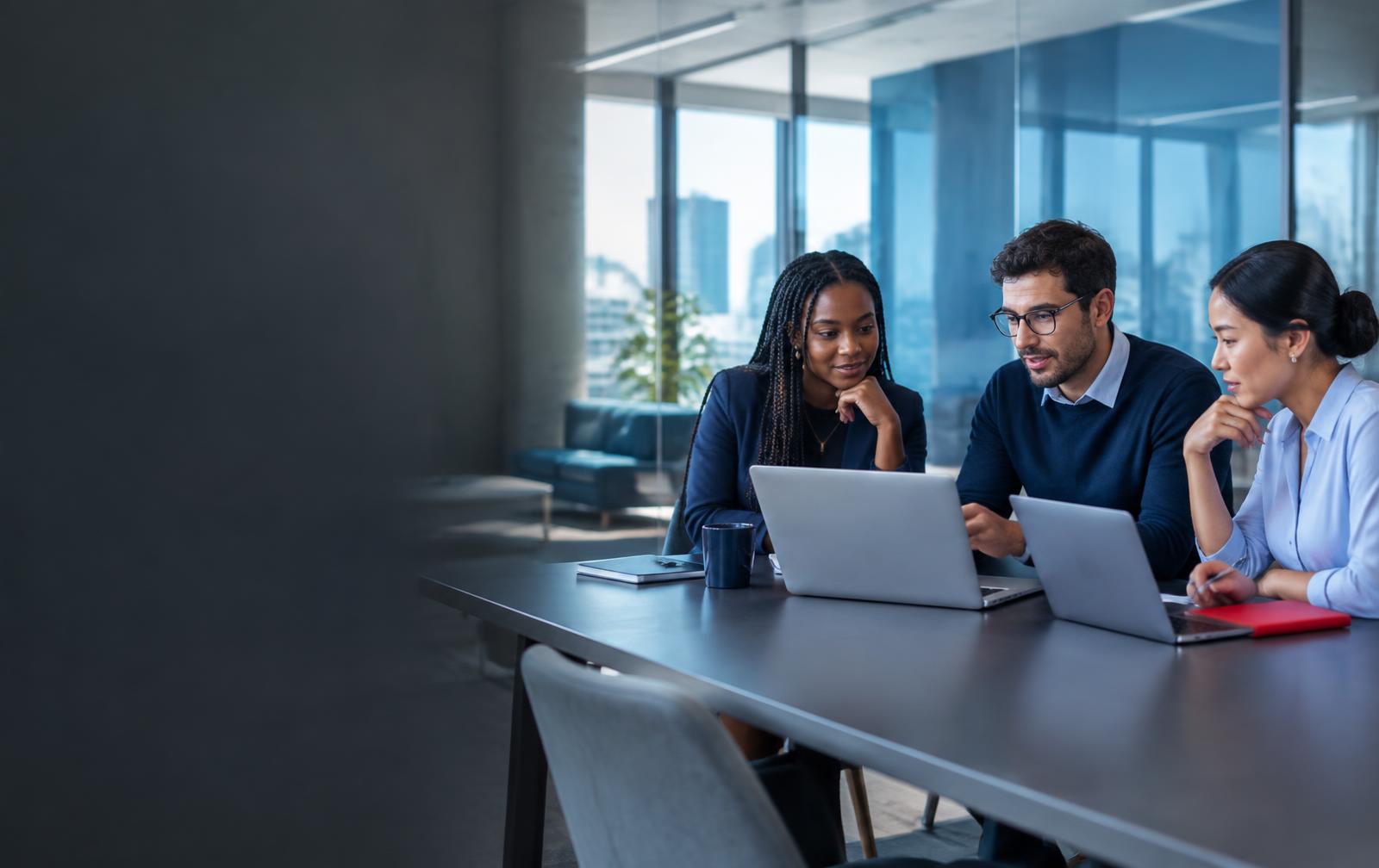 Hiring team reviewing candidates on laptops
